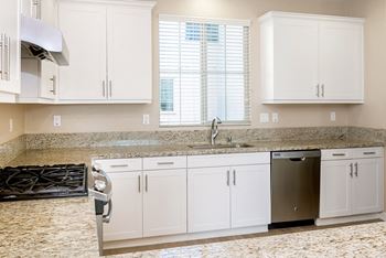 Kitchen with white cabinets and granite counter tops